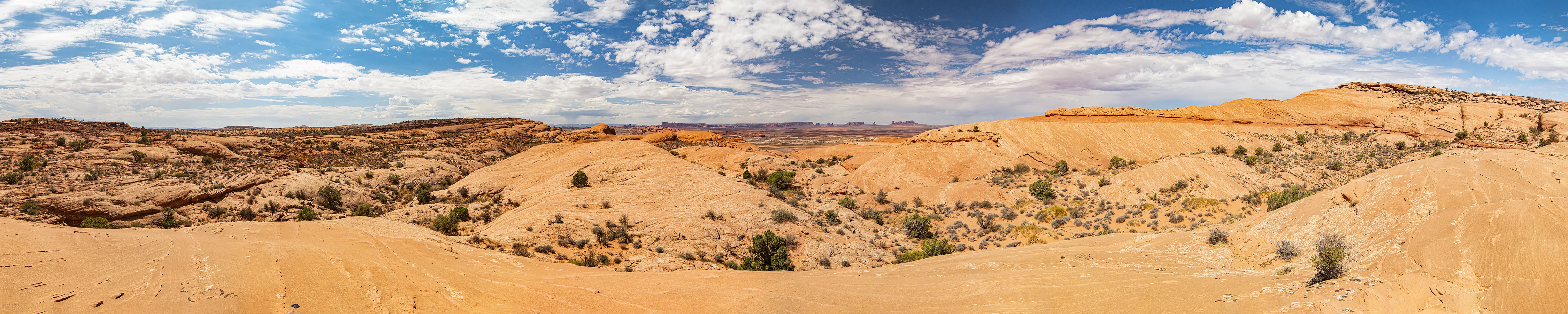 Looking west at AZ-UT Mile 244 toward the buttes of Monument Valley 27 miles away